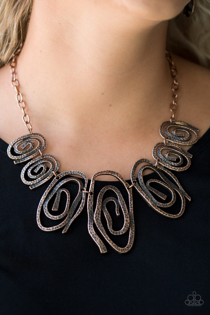 Delicately hammered in shimmery detail, warped copper frames spin into dizzying spirals. Gradually increasing in size near the center, the asymmetrical frames link below the collar for a bold tribal inspired look. Features an adjustable clasp closure.  Sold as one individual necklace. Includes one pair of matching earrings.  Always nickel and lead free.