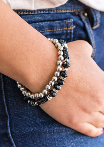 A classic strand of silver beading joins with a strand of beautiful black beading. Infused with crystal like beading, rings and beads encrusted in dazzling white and black rhinestones are sprinkled along the colorful band for a whimsical finish.  Sold as one set of two bracelets  