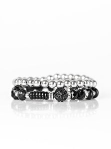 A classic strand of silver beading joins with a strand of beautiful black beading. Infused with crystal like beading, rings and beads encrusted in dazzling white and black rhinestones are sprinkled along the colorful band for a whimsical finish.  Sold as one set of two bracelets