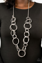 Load image into Gallery viewer,   Pairs of dramatically oversized silver hoops connect across the chest, creating an elegantly elongated statement piece for a fearless look. Features an adjustable clasp closure.  Sold as one individual necklace. Includes one pair of matching earrings.  Always nickel and lead free.