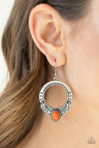 An oval orange stone is pressed into the bottom of a scalloped silver hoop stamped and studded in trendy patterns for a southwestern inspired look. Earring attaches to a standard fishhook fitting.  Sold as one pair of earrings.  Always nickel and lead free.