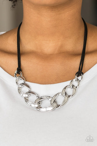 Strands of black suede knot around interconnecting silver links, creating a bold pendant below the collar. Features an adjustable clasp closure.  Sold as one individual necklace. Includes one pair of matching earrings.  Always nickel and lead free.