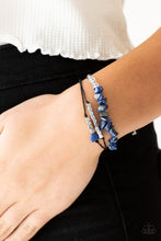 Load image into Gallery viewer, Bits of natural blue stone, clear beads, and silver cube beads are threaded along strands of dainty black cording for a seasonal look. Features an adjustable sliding knot closure.  Sold as one individual bracelet.  Always nickel and lead free.