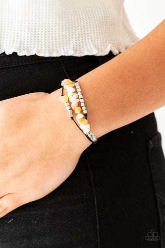 Bits of natural yellow stone, clear beads, and silver cube beads are threaded along strands of dainty black cording for a seasonal look. Features an adjustable sliding knot closure.  Sold as one individual bracelet.  Always nickel and lead free.