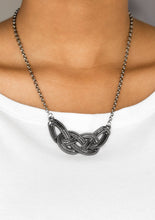Load image into Gallery viewer, Featuring chain-like patterns, antiqued gunmetal bars knot below the collar for a bold industrial look. Features an adjustable clasp closure.  Sold as one individual necklace. Includes one pair of matching earrings. 