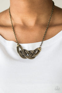 Featuring chain-like patterns, antiqued brass bars knot below the collar for a bold industrial look. Features an adjustable clasp closure.  Sold as one individual necklace. Includes one pair of matching earrings.  Always nickel and lead free.