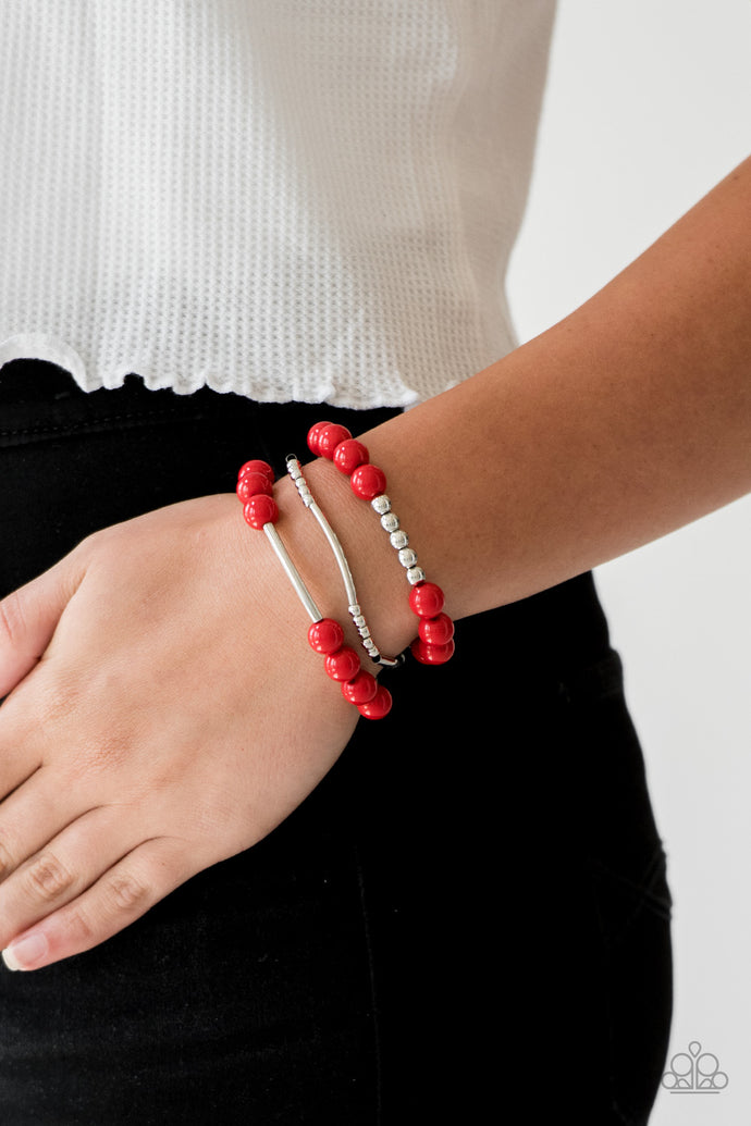 Polished red beads and mismatched silver beads are threaded along stretchy bands, creating colorful layers across the wrist.  Sold as one set of three bracelets.  Always nickel and lead free.