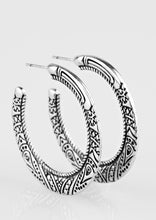 Load image into Gallery viewer, Embossed in tribal inspired patterns, a glistening silver hoop curls around the ear for an indigenous look. Earring attaches to a standard post fitting. Hoop measures 1 1/2&quot; in diameter.  Sold as one pair of hoop earrings.