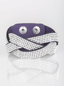 Encrusted in row after row of glittery white rhinestones, three blue suede bands braid across the wrist for a sassy look. Features an adjustable snap closure.  Sold as one individual bracelet.  