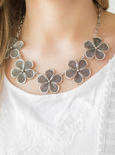 Load image into Gallery viewer, Featuring lace-like petals, glistening silver daisies link below the collar for a seasonal look. Features an adjustable clasp closure.  Sold as one individual necklace. Includes one pair of matching earrings.