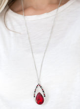 Load image into Gallery viewer, A fiery red teardrop gem is pressed into a silver frame radiating with black, hematite, and red rhinestones. The glamorous pendant swings from the bottom of a shimmery silver chain for a refined look. Features an adjustable clasp closure.  Sold as one individual necklace. Includes one pair of matching earrings.  Always nickel and lead free.