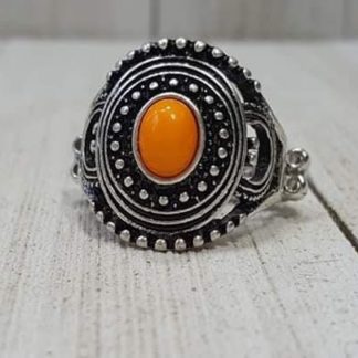 A shiny orange bead is pressed into the center of a round frame radiating with silver studded detail for a seasonal look. Features a dainty stretchy band for a flexible fit.  Sold as one individual ring.  Always nickel and lead free  Fashion Fix Exclusive!!