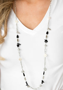 Brushed in shell-like iridescence, bits of black and white stone beading trickles along a shimmery silver chain. Mismatched silver accents are sprinkled between the earthy accents for a seasonal finish. Features an adjustable clasp closure.  Sold as one individual necklace. Includes one pair of matching earrings.