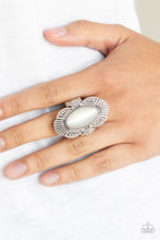 Load image into Gallery viewer, A white oval cat&#39;s eye stone is pressed into the center of a scalloped silver frame radiating with linear detail for a whimsical flair. Features a stretchy band for a flexible fit.  Sold as one individual ring.  Always nickel and lead free.