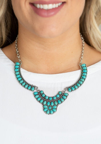 Featuring round and teardrop shapes, a collection of tranquil turquoise stone beads are pressed into interconnected silver plates, creating a refreshing floral inspired statement piece below the collar. Features an adjustable clasp closure.  Sold as one individual necklace. Includes one pair of matching earrings.