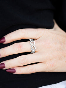 Encrusted in glittery white rhinestones, a silver infinity loops across the finger in a timeless fashion. Features a dainty stretchy band for a flexible fit.  Sold as one individual ring.