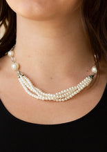 Load image into Gallery viewer, Oversized white pearls and crystal-like beads give way to layers of beaded pearl strands below the collar for a timeless look. Features an adjustable clasp closure.  Sold as one individual necklace. Includes one pair of matching earrings.  Always nickel and lead free.