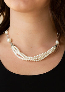 Oversized white pearls and crystal-like beads give way to layers of beaded pearl strands below the collar for a timeless look. Features an adjustable clasp closure.  Sold as one individual necklace. Includes one pair of matching earrings.  Always nickel and lead free.