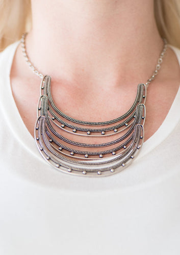 Studded in antiqued texture, three horse shoe shaped frames connect below the collar in a bold fashion. Features an adjustable clasp closure.  Sold as one individual necklace. Includes one pair of matching earrings.  