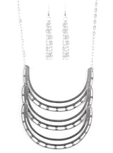 Load image into Gallery viewer, Studded in antiqued texture, three horse shoe shaped frames connect below the collar in a bold fashion. Features an adjustable clasp closure.  Sold as one individual necklace. Includes one pair of matching earrings.  
