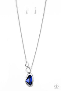 A faceted blue gem is nestled inside of a shimmery silver frame encrusted in dainty white rhinestones. The glittery pendant asymmetrically links with abstract silver frames at the bottom of a lengthened silver rounded snake chain for a modern look. Features an adjustable clasp closure.  Sold as one individual necklace. Includes one pair of matching earrings.  