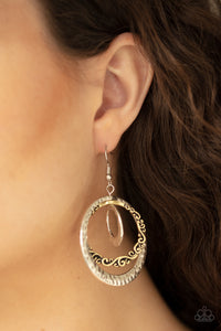 A collection of hammered and filigree filled silver and brass hoops ripple from the ear, coalescing into a dizzying frame. Earring attaches to a standard fishhook fitting.  Sold as one pair of earrings.   Always nickel and lead free.