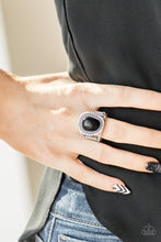 Load image into Gallery viewer, An earthy black stone is pressed into an asymmetrical silver frame radiating with tactile textures for a seasonal look. Features a stretchy band for a flexible fit.  Sold as one individual ring.   Always nickel and lead free.  Item #P4SE-BKXX-075XX
