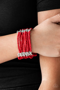 Joined together with metallic fittings, countless red seed beads are threaded along stretchy elastic bands. Sections of dainty silver beads are sprinkled along the colorful layers, adding hints of shimmer to the seasonal palette.  Sold as one individual bracelet.  Always nickel and lead free.