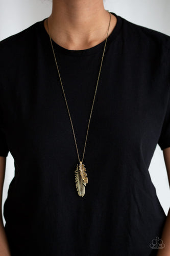 An aurum rhinestone encrusted brass feather joins a lifelike brass feather at the bottom of a lengthened brass chain, creating a whimsical pendant. Features an adjustable clasp closure.  Sold as one individual necklace. Includes one pair of matching earrings.  Always nickel and lead free.