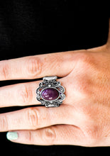 Load image into Gallery viewer, A purple bead is pressed into the center of a regal silver frame. Dazzling white rhinestones are sprinkled along fancy silver filigree, creating a stunning band. Features a stretchy band for a flexible fit.   Sold as one individual ring,