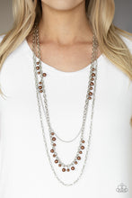 Load image into Gallery viewer, Three mismatched silver chains layer down the chest. Dainty brown pearls cascade down one silver chain, adding a flirty twist to the timeless pearl palette. Features an adjustable clasp closure.  Sold as one individual necklace. Includes one pair of matching earrings.  Always nickel and lead free.