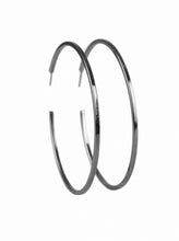 Load image into Gallery viewer, A glistening gunmetal hoop curls around the ear for a casual look. Earring attaches to a standard post fitting. Hoop measures 2 1/2&quot; in diameter.  Sold as one pair of hoop earrings.
