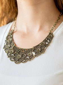 Featuring lattice-like patterns, shimmery brass flowers bloom below the collar for a seasonal look. Features an adjustable clasp closure.  Sold as one individual necklace. Includes one pair of matching earrings.
