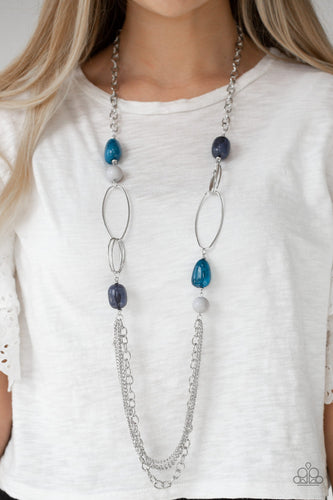 Featuring polished and cloudy faux rock finishes, gray and blue beads link with bold silver hoops. The whimsical compilation gives way to layers of mismatched silver chains for a seasonal finish. Features an adjustable clasp closure.  Sold as one individual necklace. Includes one pair of matching earrings.
