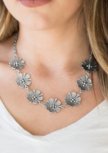 Load image into Gallery viewer, Featuring lifelike detail, a row of shimmery silver flowers links below the collar for a seasonal look. Features an adjustable clasp closure.  Sold as one individual necklace. Includes one pair of matching earrings.