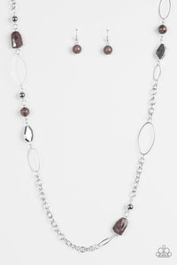 Featuring round and faceted shapes, smoky and shiny silver beads trickle along a bold silver chain for a seasonal look. Features an adjustable clasp closure.  Sold as one individual necklace. Includes one pair of matching earrings.