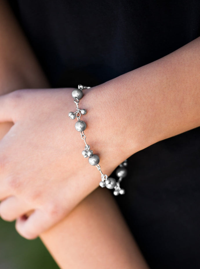 Clusters of dainty silver pearls join classic silver pearls around the wrist, creating a timeless look. Features an adjustable clasp closure.  Sold as one individual bracelet.  