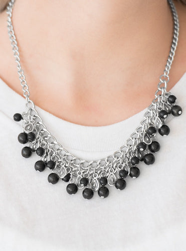 Earthy black stone beading cascades from the bottom of interlocking silver chains, creating an earthy fringe below the collar. Brushed in an antiqued shimmer, textured silver teardrops drip between the colorful beading for an artisan inspired finish. Features an adjustable clasp closure.  Sold as one individual necklace. Includes one pair of matching earrings.