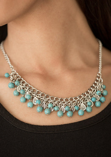 Earthy turquoise stone beading cascades from the bottom of interlocking silver chains, creating an earthy fringe below the collar. Brushed in an antiqued shimmer, textured silver teardrops drip between the colorful beading for an artisan inspired finish. Features an adjustable clasp closure.  Sold as one individual necklace. Includes one pair of matching earrings.