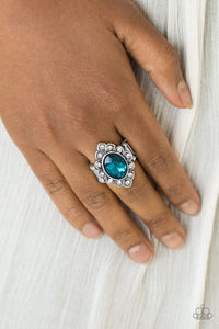 A glassy blue gem is pressed into a marquise-shaped silver frame radiating with glittery white rhinestones for a regal look. Features a stretchy band for a flexible fit.  Sold as one individual ring.  Always nickel and lead free.