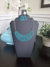 Load image into Gallery viewer, Painted in a shiny blue finish, a shattered metallic pendant swings below the collar for a dramatic look. The bold pendant is suspended from glistening silver chains for a shock of contrasting color. Features an adjustable clasp closure.  Sold as one individual necklace. Includes one pair of matching earrings.  Always nickel and lead free.  August 2020 Fashion Fix Exclusive!