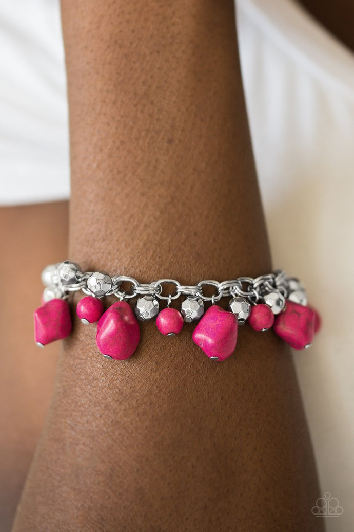 Featuring round and asymmetrical cuts, vivacious pink stones trickle from the bottom of a double chain-linked chain. Faceted silver beads trickle between the stones, adding a splash of metallic shimmer to the earthy fringe. Features an adjustable clasp closure.  Sold as one individual bracelet.  Always nickel and lead free.
