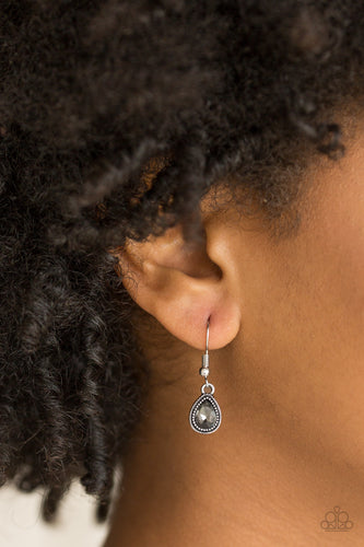 A smoky teardrop rhinestone is pressed into the center of a studded silver frame for a timeless look. Earring attaches to a standard fishhook fitting.  Sold as one pair of earrings.  Always nickel and lead free. 