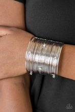 Load image into Gallery viewer, Shimmery silver wires wrap back and forth along a silver frame, creating a bold cuff. Glassy white rhinestones are sprinkled across the dramatic cuff for a glamorous finish.  Sold as one individual bracelet.  Always nickel and lead free.