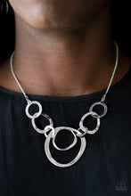 Load image into Gallery viewer, Delicately hammered in shimmery textures, abstract circle frames interlock below the collar for a modernly metro look. Features an adjustable clasp closure.  Sold as one individual necklace. Includes one pair of matching earrings.  Always nickel and lead free.