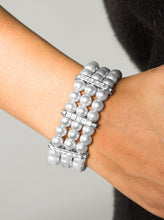 Load image into Gallery viewer, Classic silver pearls are threaded along elastic stretchy bands, creating colorful layers across the wrist. Encrusted in glittery white rhinestones, shimmery silver frames fit around the pearl strands, joining the bracelets.  Sold as one individual bracelet.  