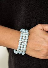 Load image into Gallery viewer, Classic blue pearls are threaded along elastic stretchy bands, creating colorful layers across the wrist. Encrusted in glittery white rhinestones, shimmery silver frames fit around the pearl strands, joining the bracelets.  Sold as one individual bracelet.