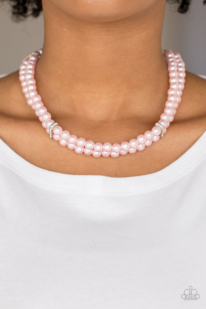 Pinched between white rhinestone encrusted frames, strands of classic pink pearls layer below the collar for a timeless look. Features an adjustable clasp closure.  Sold as one individual necklace. Includes one pair of matching earrings.   Always nickel and lead free.