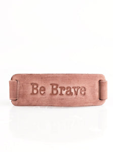Brushed in a rustic finish, a brown leather band is stamped in the phrase, “Be Brave” for an inspiring finish. Features an adjustable snap closure.  Sold as one individual bracelet.