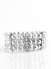 Load image into Gallery viewer, Classic silver pearls are threaded along elastic stretchy bands, creating colorful layers across the wrist. Encrusted in glittery white rhinestones, shimmery silver frames fit around the pearl strands, joining the bracelets.  Sold as one individual bracelet.